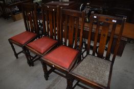 A set of four early 20th Century oak rail back dining chairs