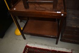 A traditional tea trolley having fold over games top lined with green beize