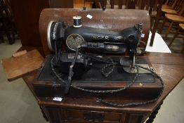 A vintage singer sewing machine (electric) in oak case , wiring removed for safety