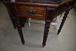 A late 19th Century oak hall table having canted front on twist legs with frieze drawer, width
