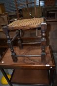 A traditional cane seated stool and folding cake stand