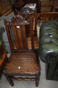 A pair of period oak hall or side chairs having solid seats