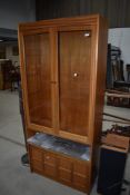 A vintage Nathan teak book/display case having shelf and double cupboard under, width approx. 88cm