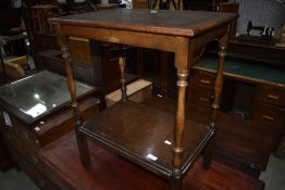 An early to mid 20th Century oak tea table with undertier