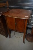 An Edwardian mahogany and inlaid side cabinet on slender shaped legs