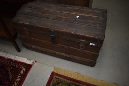 A vintage dome top travel trunk