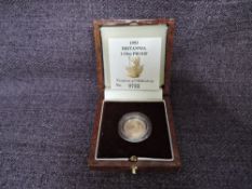 A 1993 Queen Elizabeth II 1/10 oz 10 Pound Gold Proof Britannia Coin, in original box with