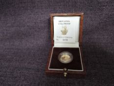 A 1991 Queen Elizabeth II 1/10 oz 10 Pound Gold Proof Britannia Coin, in original box with