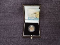 A 2006 Queen Elizabeth II 1/10 oz 10 Pound Gold Proof Britannia Coin, in original box with