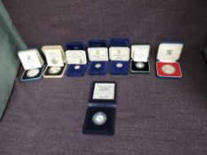 A collection of Eight Elizabeth II United Kingdom Five Pound Silver Proof Coins in original boxes