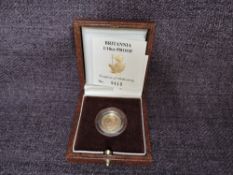 A 1990 Queen Elizabeth II 1/10 oz 10 Pound Gold Proof Britannia Coin, in original box with