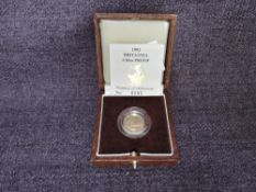 A 1992 Queen Elizabeth II 1/10 oz 10 Pound Gold Proof Britannia Coin, in original box with