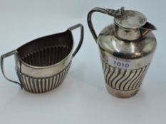 A small Victorian silver lidded jug having gadrooned decoration, Birmingham 1894, Stokes & Ireland