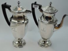 A silver coffee pot and matching hot water jug, each having tapering octagonal bodies to pedestal