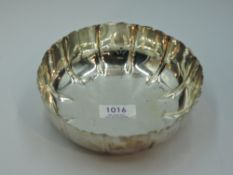 A silver bowl of circular form having indented decoration, London 1944, makers mark worn, approx