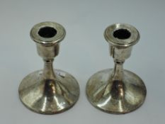 A pair of silver candle sticks of short plain circular form, Birmingham 1923, Sydney & Co, approx