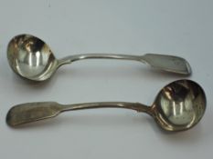 A pair of Georgian silver sauce ladles of fiddle back form bearing monogram to terminals, London