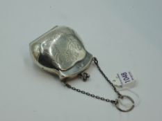 A silver chatelaine coin purse having engraved ribbon and swag decoration and tan leather lining,