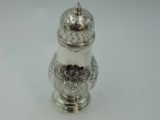 A Victorian silver sugar caster of baluster form having engraved panel decoration with plain