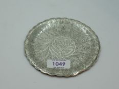 An Egyptian silver bottle saucer having extensive engraved decoration and shaped rim, approx 68.7g