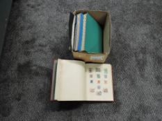 A box containing World used and mint Stamps in albums and packs