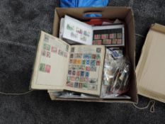 A box of World Stamps including Victory Album and Kiloware