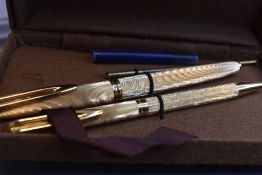 A boxed Waterman cartridge/ converter fountain pen with 18k nib and ballpoint pen in gold