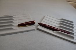 A Parker 17 lady fountain pen in burgundy with narrow band to the cap. Approx 11.7cm