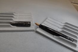 A Parker Vacumatic fountain pen in black and pearl with two narrow bands to the cap and having a