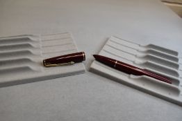 A Parker 17 lady fountain pen in burgundy with narrow band to the cap. Approx 11.7cm