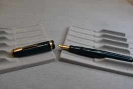 A Parker Duofold fountain pen in green with broad decorative band to the cap and having a Parker