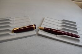 A Parker Duofold fountain pen in burgundy with broad decorative band to the cap and having a
