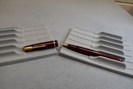 A Parker Slimfold fountain pen in burgundy with narrow decorative band to the cap and having a