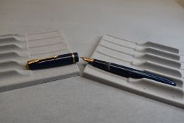 A Parker Slimfold fountain pen in blue with narrow decorative band to the cap and having a Parker