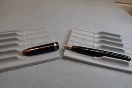A Parker Vacumatic fountain pen in black with broad decorative band to the cap and having a Parker