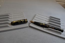 A Conway Stewart 55 leverfil fountain pen in green/black marble with two narrow and one broad band