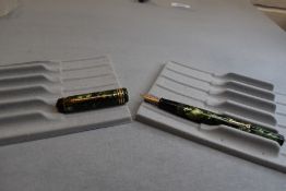 A Conway Stewart 388 leverfil fountain pen in green marble with two narrow and one broad band to the