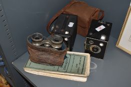 Two photographic box cameras and a pair of vintage binoculars