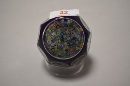 A Perthshire glass close-pack milliefiori paperwight, purple cased with wheel-cut 'windows' re-
