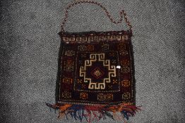 A North West Persian saddle bag having a central stylised medallion with repeating geometric border