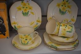 An Art |Deco era Pheonix Ware part tea service, having hand-painted daffodil flower panels