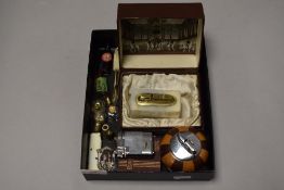 A small selection of curios including cigarette and table top lighters also scent bottles