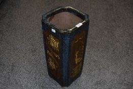 A glazed pottery stickstand or planter, of square section decorated with panels of flora and fauna