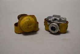A mid century spy style miniature camera by Hit Japan with yellow case