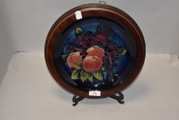 A modern Moorcroft display plate designed by Sally Tuffin in the Finch and Fruit design