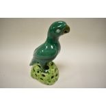 A late 18th / early 19th century green glazed Chinese figure of a parrot perched on top of