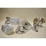 A cow and pig figure base by Lladro with similar porcelain plaque also two Nao dog figures and a