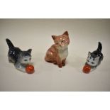 Three cat figures including Beswick seated cat and two Geobels cats playing with ball