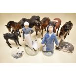 Five Beswick horses; stocky jogging mare, black beauty and mare facing left, black beauty foal,one