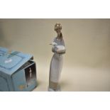 A boxed figure study by Lladro of girl holding lamb
